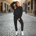 Woman in black outfit standing on a cobblestone street