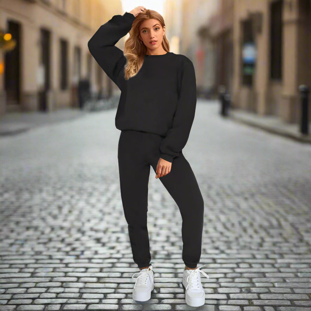 Woman in black outfit standing on a cobblestone street