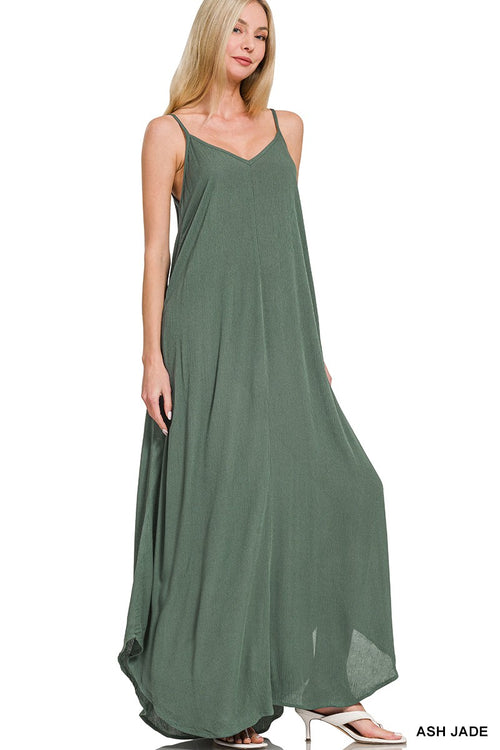 Woman wearing a green maxi dress on a white background