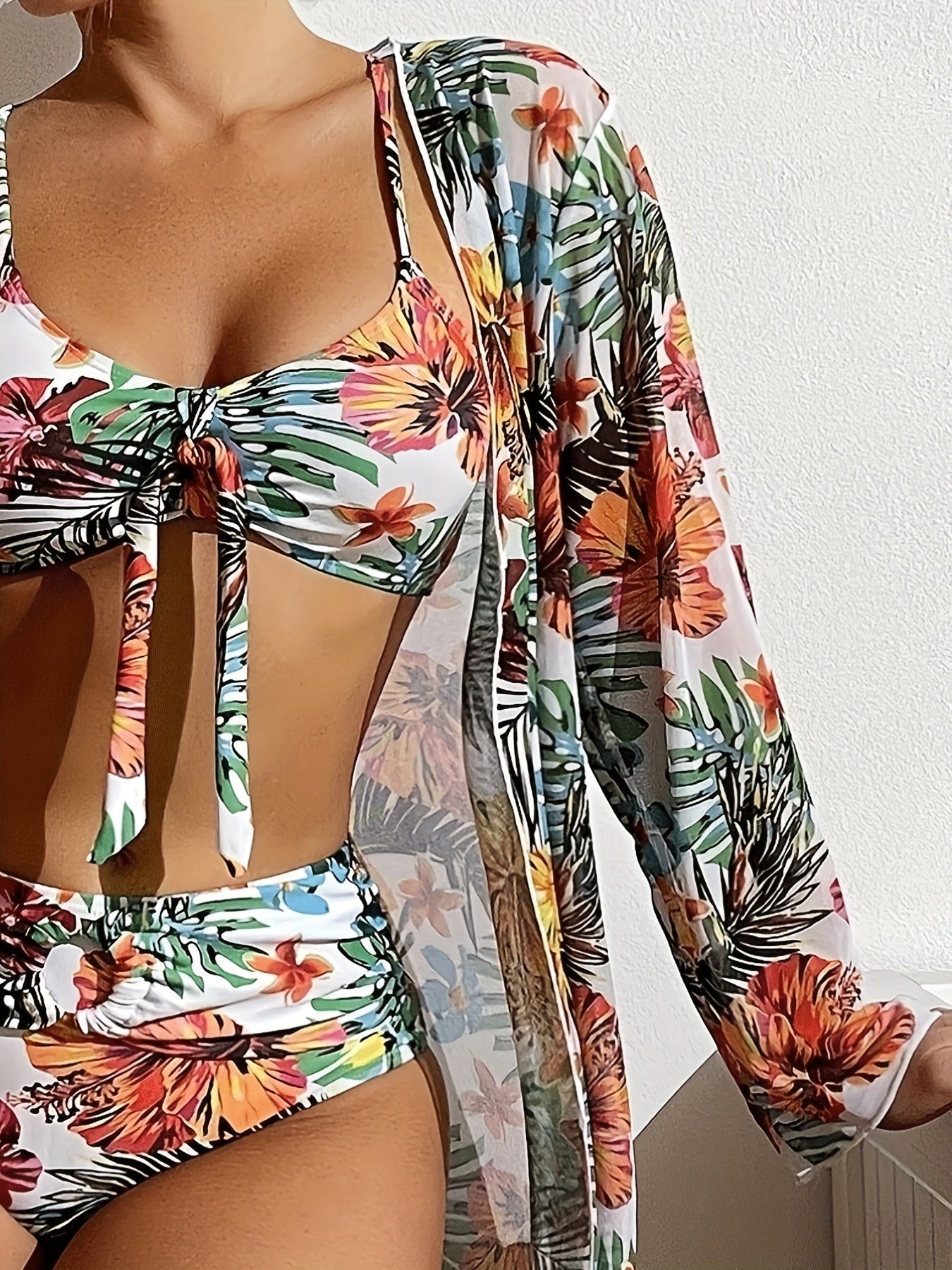 Tropical floral bikini set with matching cover-up on a white background
