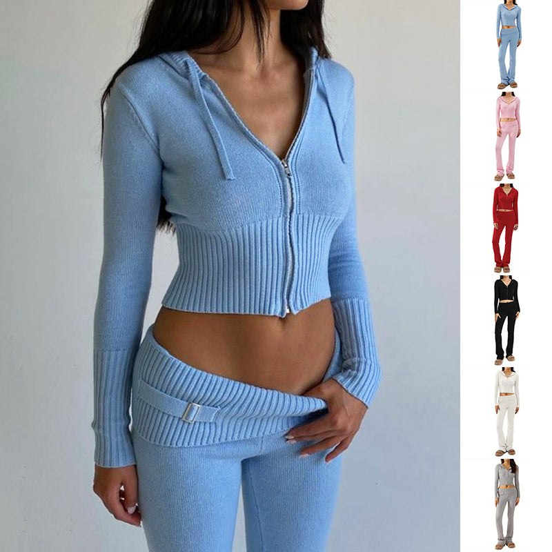Woman wearing a blue ribbed knit outfit with matching pants on a plain background.