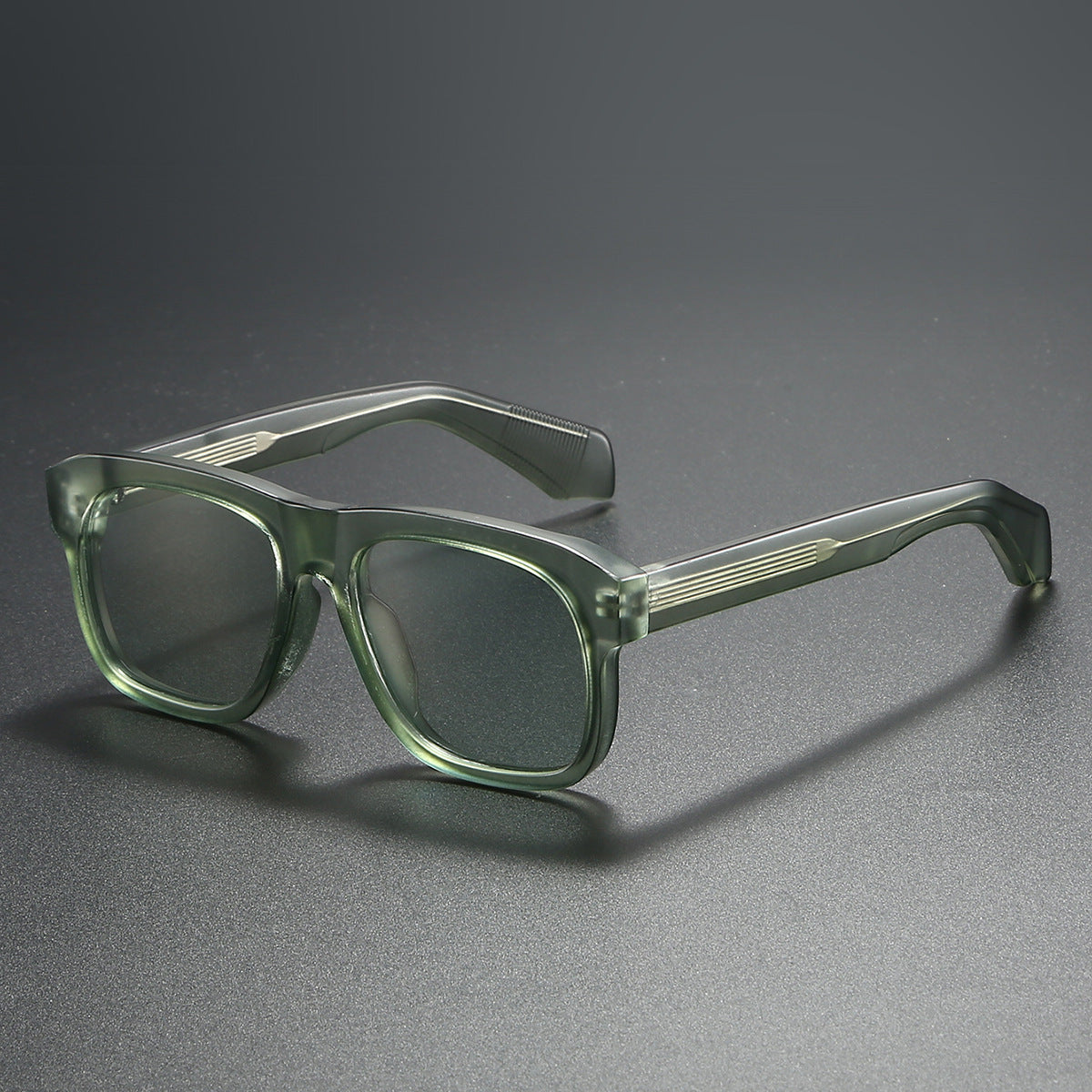 Green eyeglasses on a gray background
