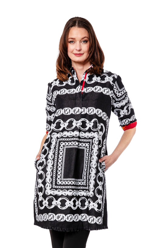 Woman wearing a black dress with white chain pattern on a white background