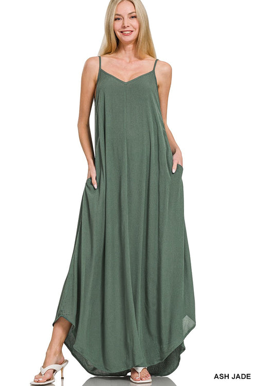 Woman wearing a green maxi dress on a white background