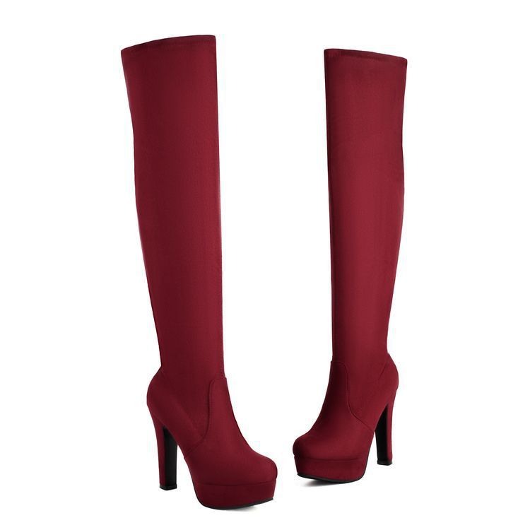Red knee-high boots on a white background