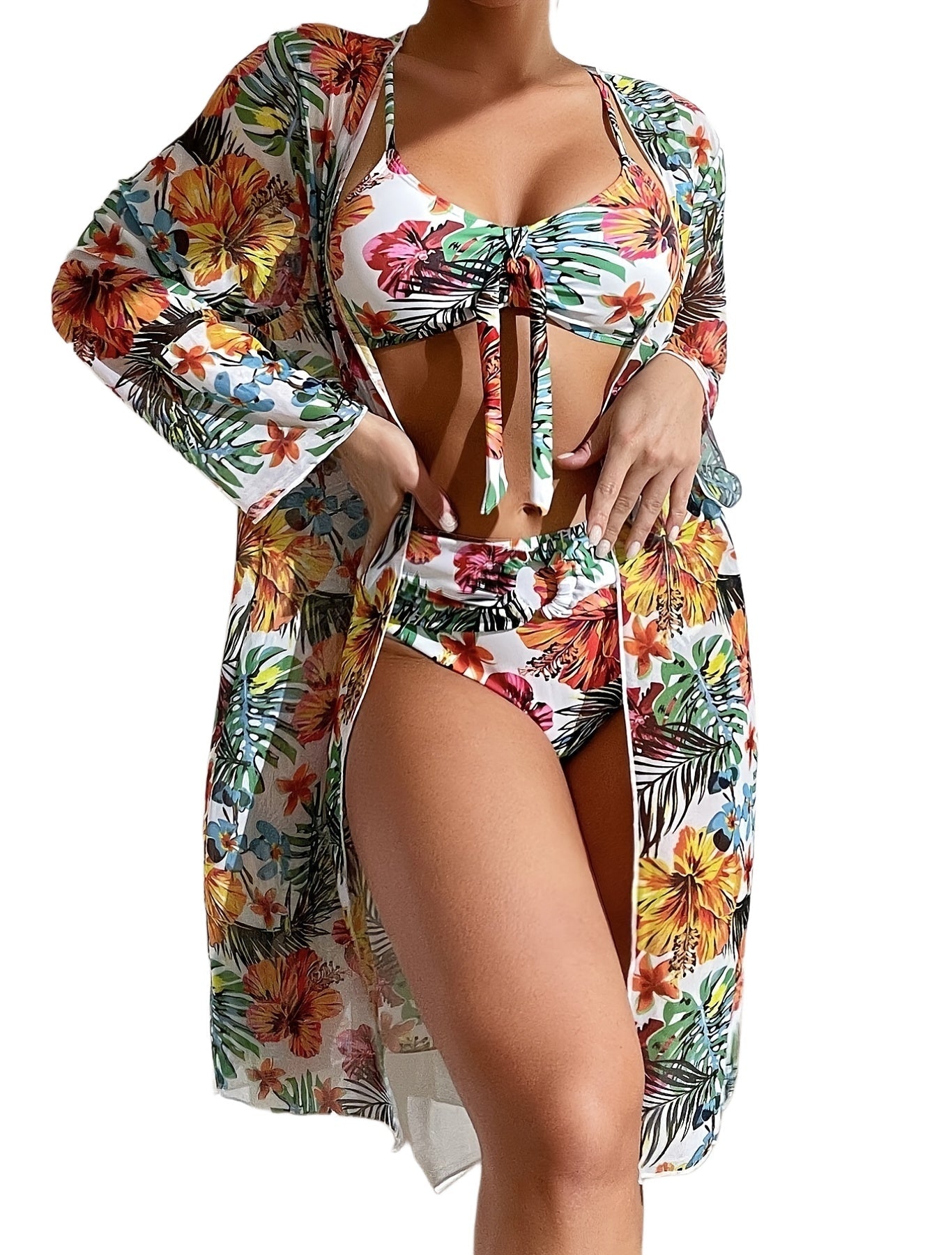 Woman wearing a colorful floral swimsuit with matching cover-up on a white background