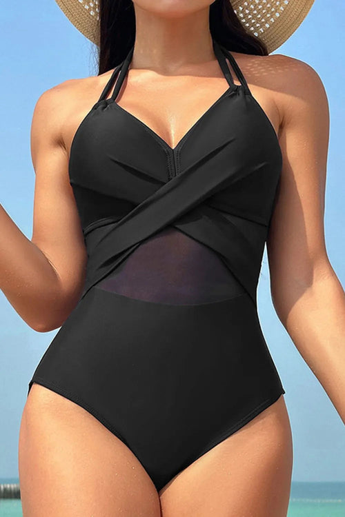 Woman wearing a black swimsuit with a blue sky background