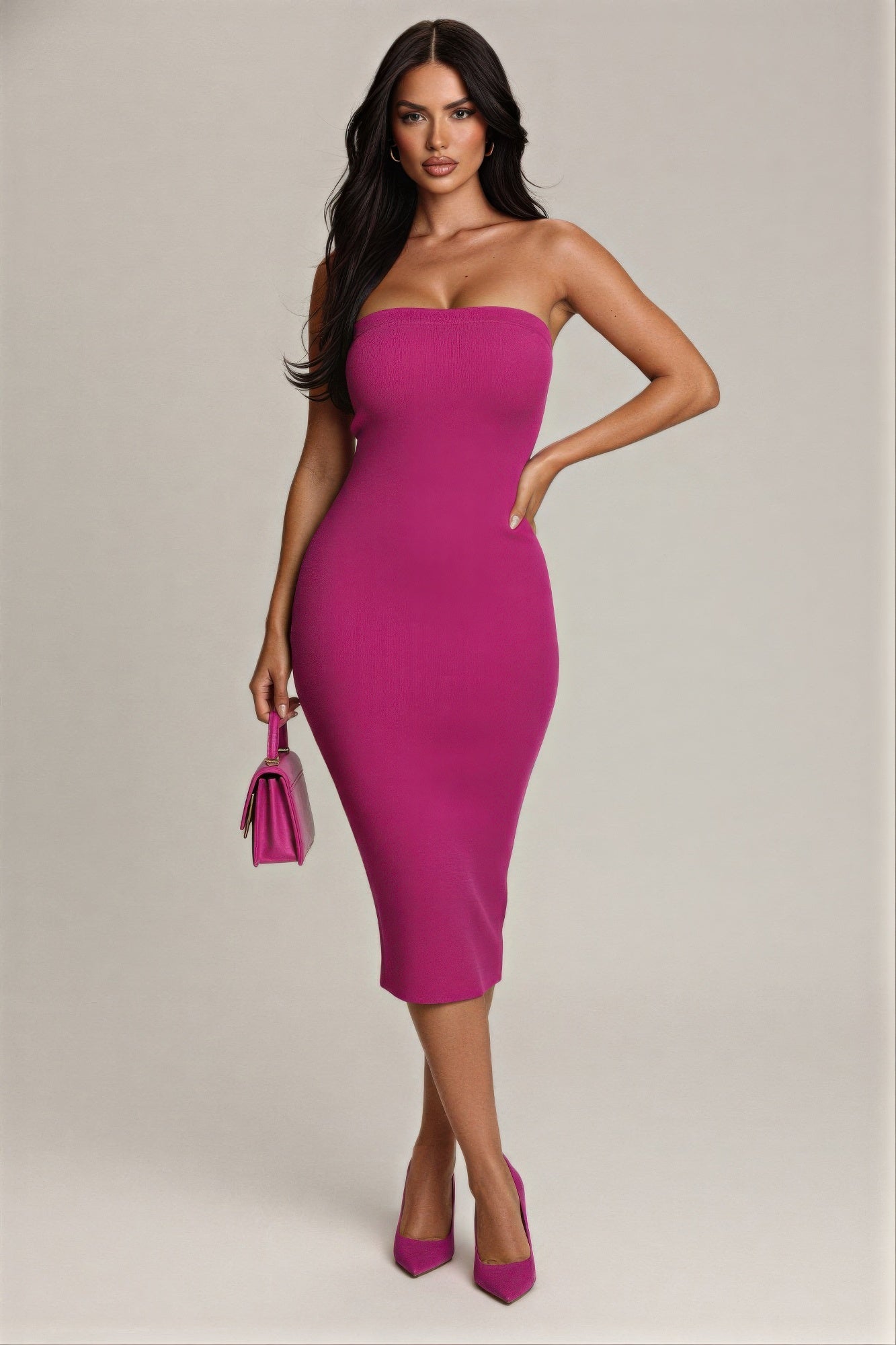 Woman wearing a strapless pink dress holding a matching handbag against a neutral background