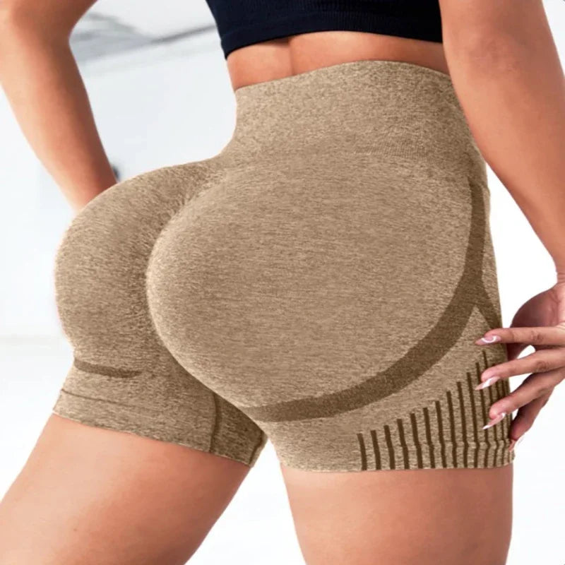 Beige compression shorts worn by a person on a white background