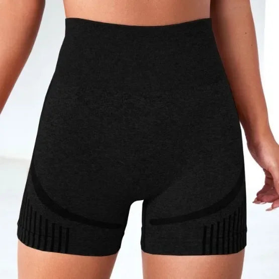 Black high-waisted shorts worn by a person on a white background