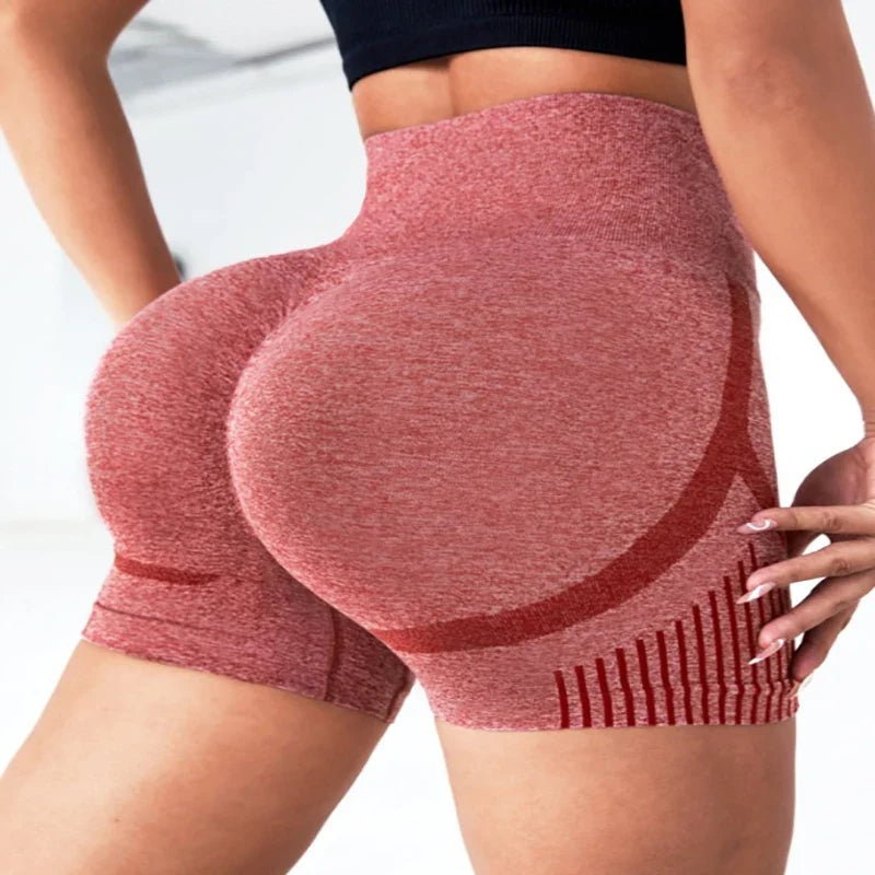 Red high-waisted shorts worn by a person on a white background
