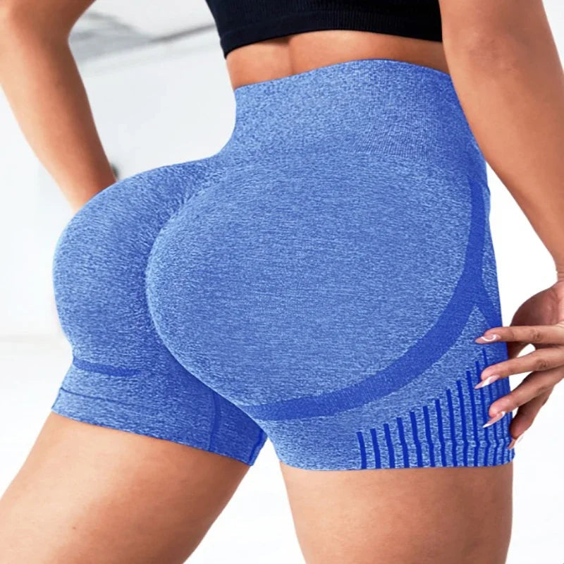 Blue athletic shorts worn by a person on a white background