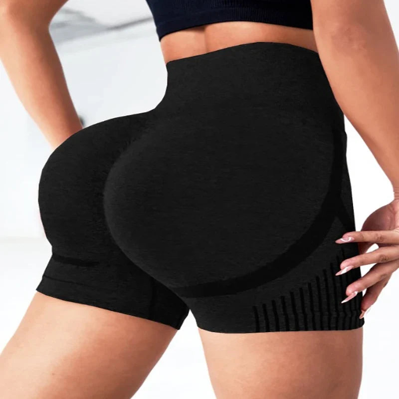 Black high-waisted shorts worn by a person on a white background