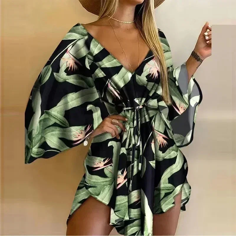 Woman wearing a green and black patterned dress with a beige background