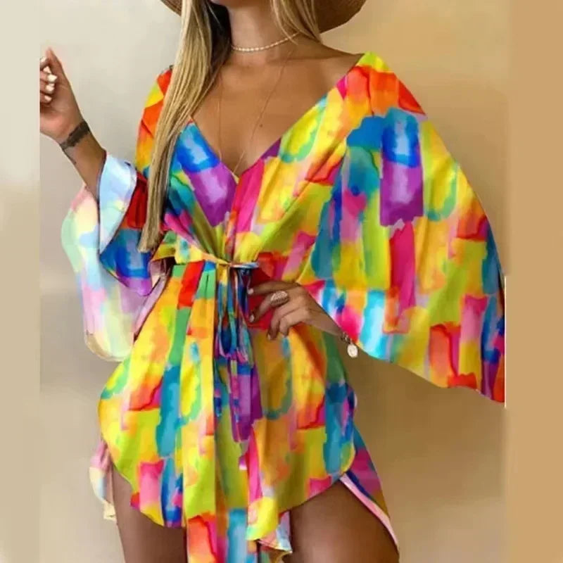 Woman wearing a colorful tie-dye dress against a beige background
