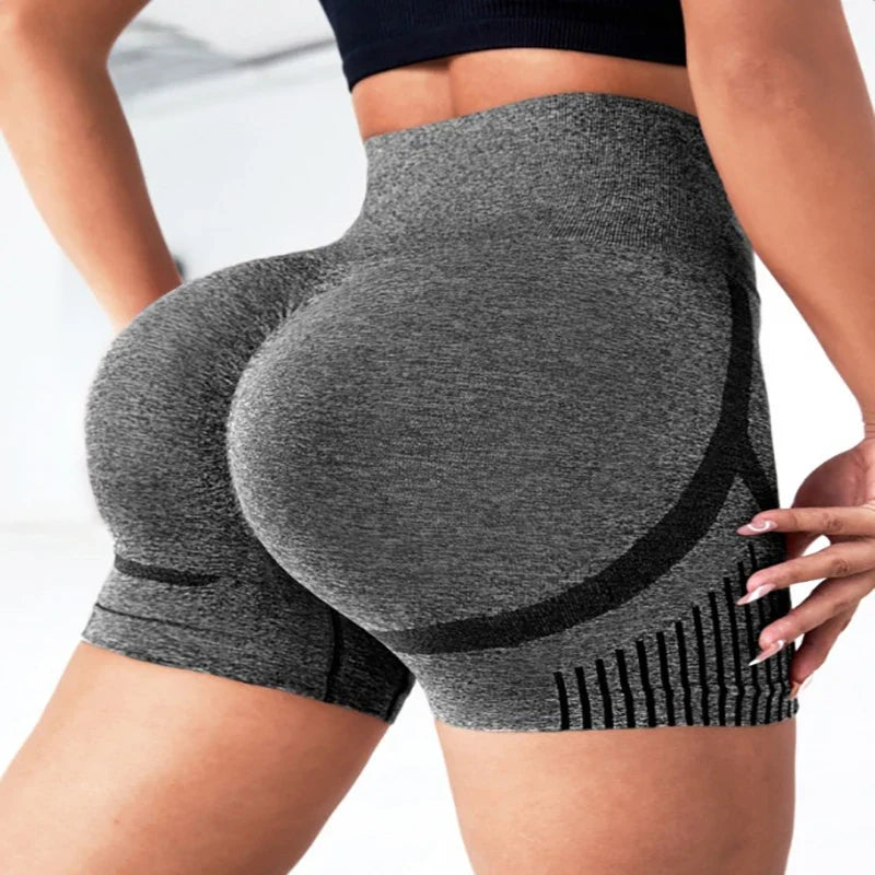 Person wearing gray high-waisted shorts with black accents on a white background