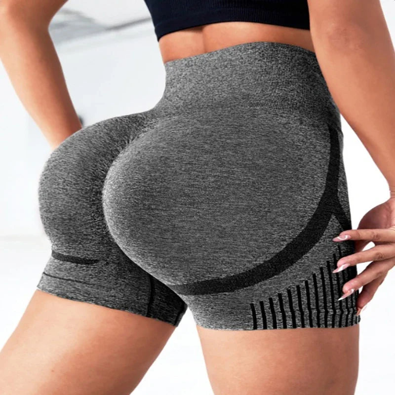 Person wearing gray high-waisted shorts with black accents on a white background