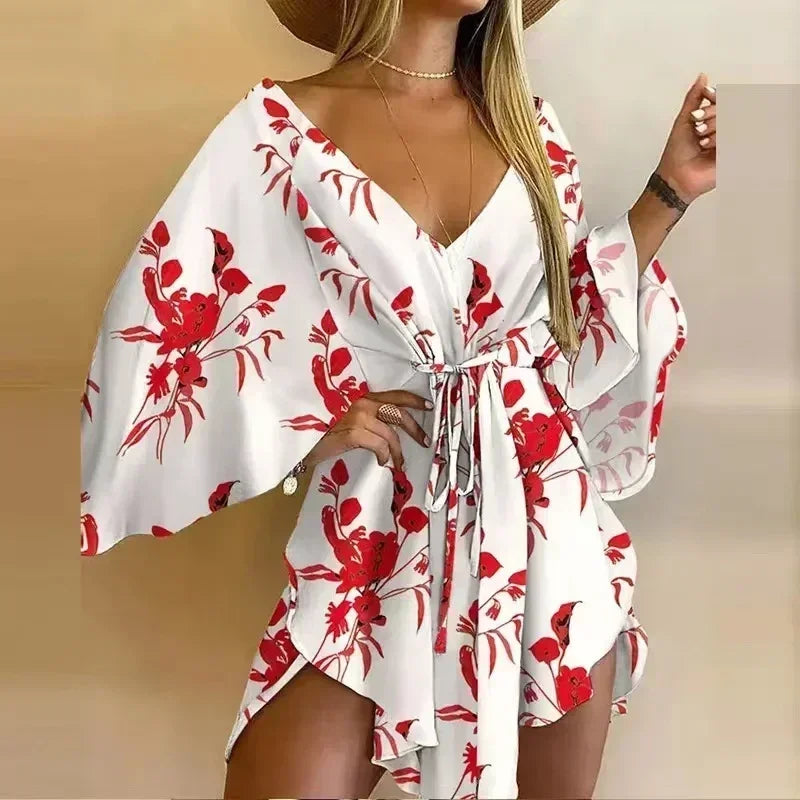 White dress with red floral pattern worn by a model on a beige background
