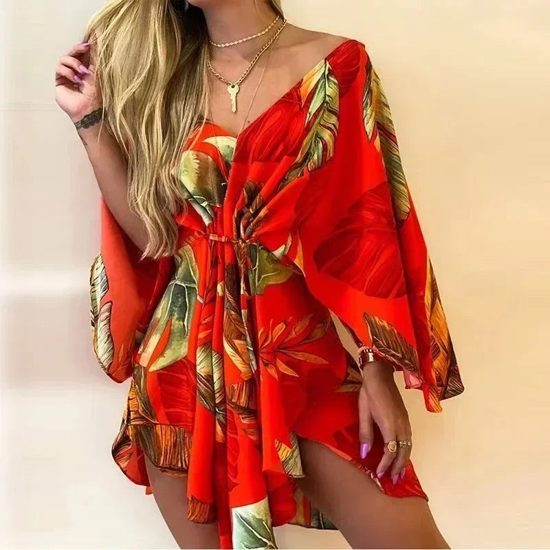 Woman wearing a red and gold floral dress against a beige background