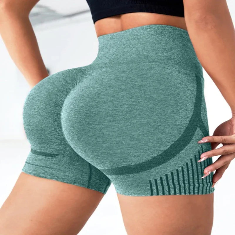 Green athletic shorts worn by a person on a white background