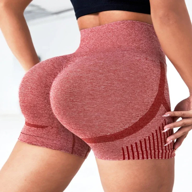 Red high-waisted shorts worn by a person on a white background