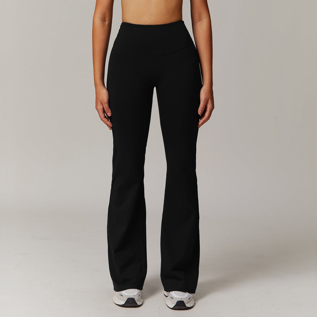 Person wearing black pants on a plain background