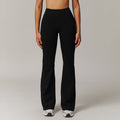 Person wearing black pants on a plain background