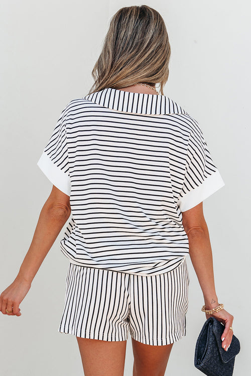 Person wearing a black and white striped outfit with a plain background showing the back of the set