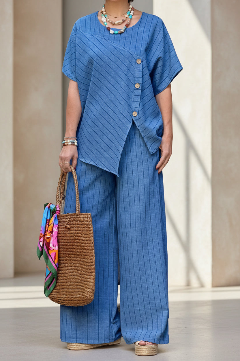 Person wearing a blue outfit holding a woven bag indoors.