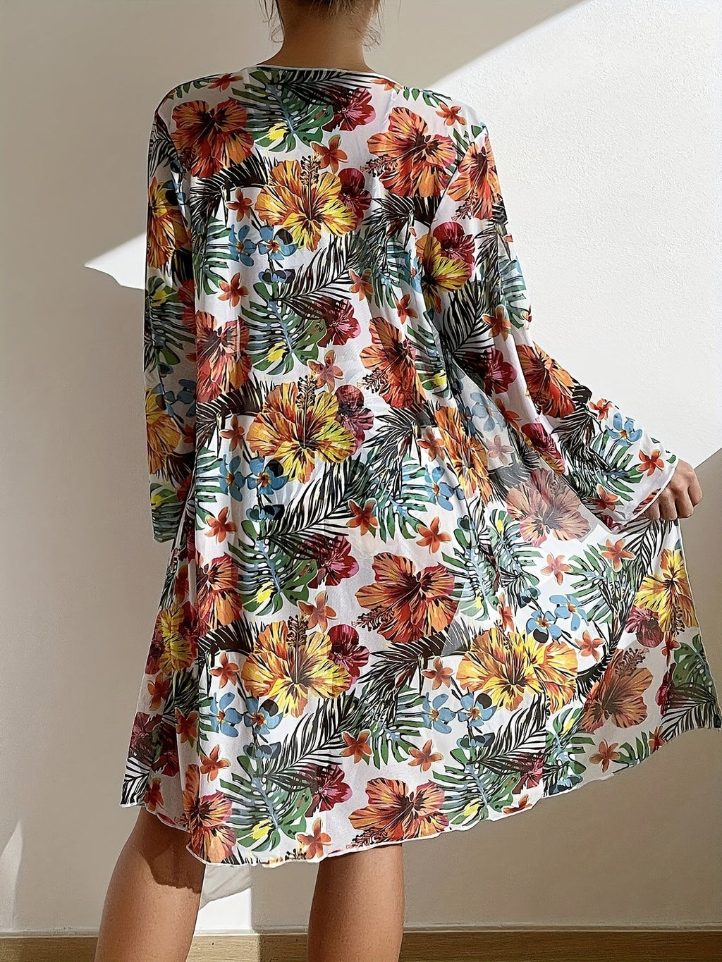 Floral patterned kimono-style garment on a plain background