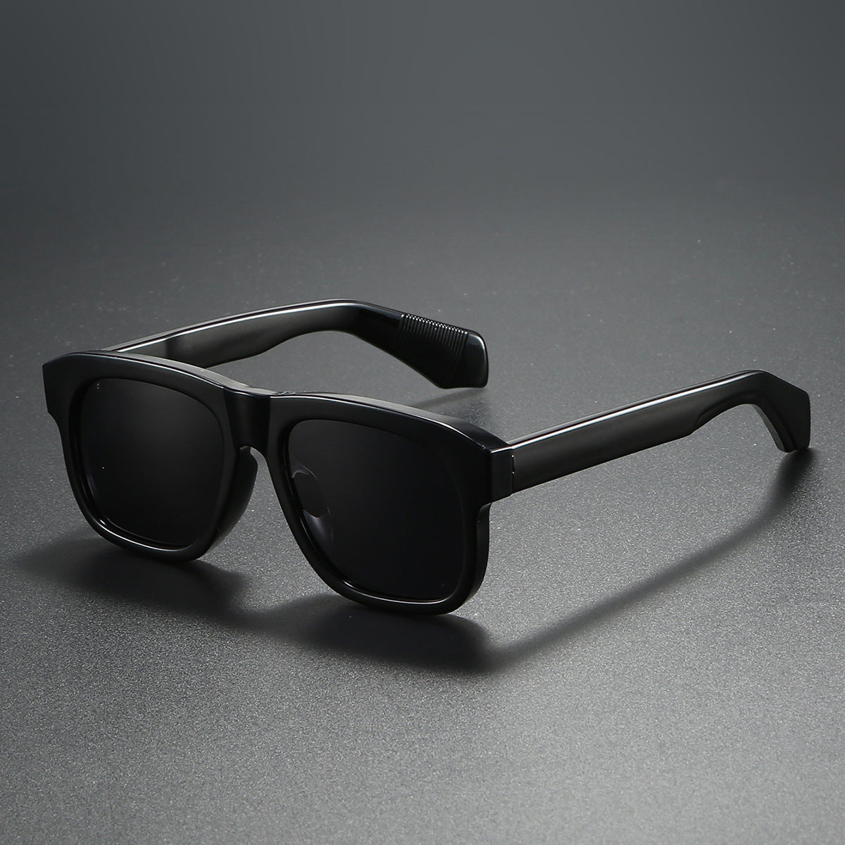Black sunglasses on a gray background