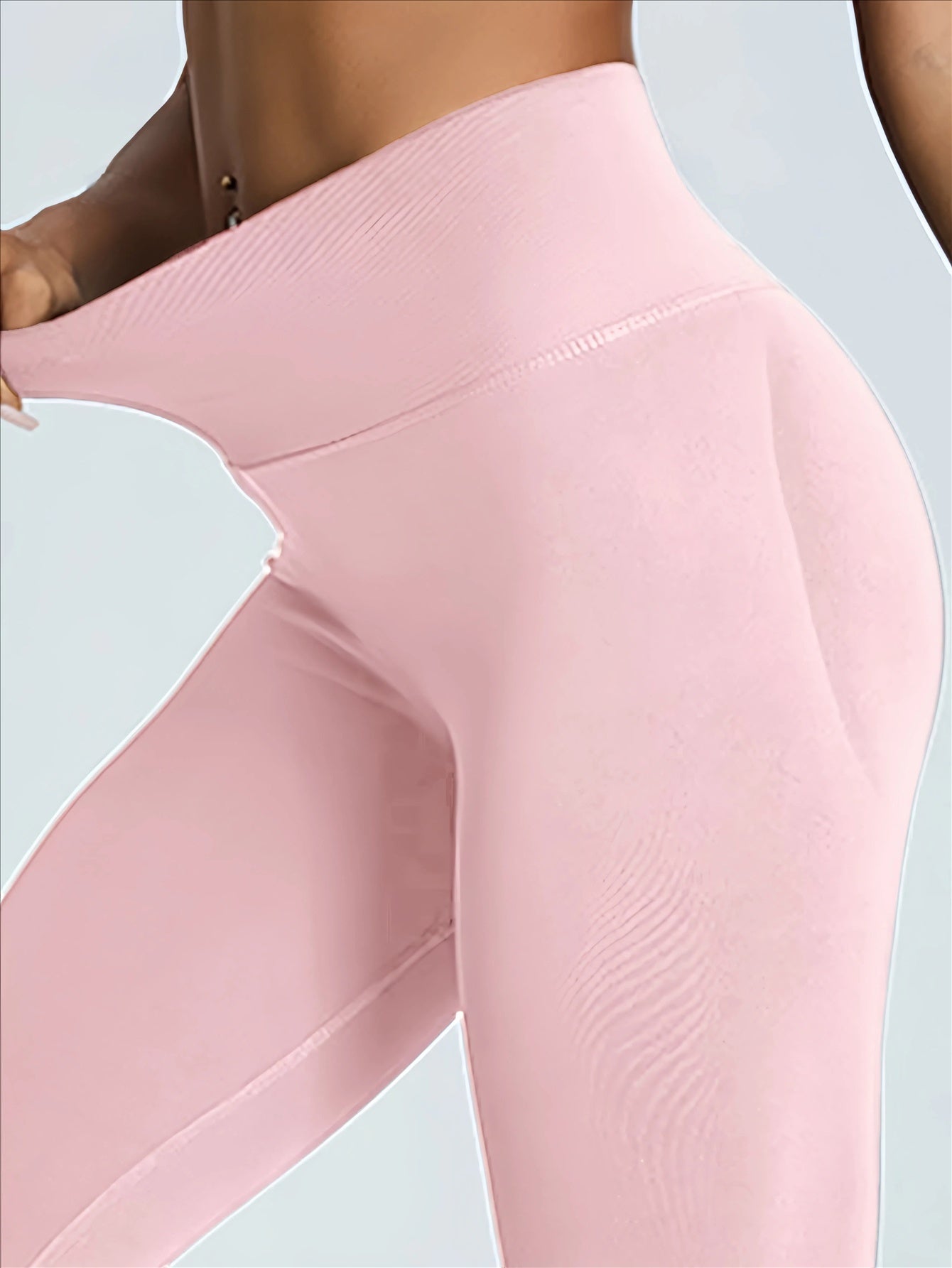 Close-up of pink leggings with a light blue background