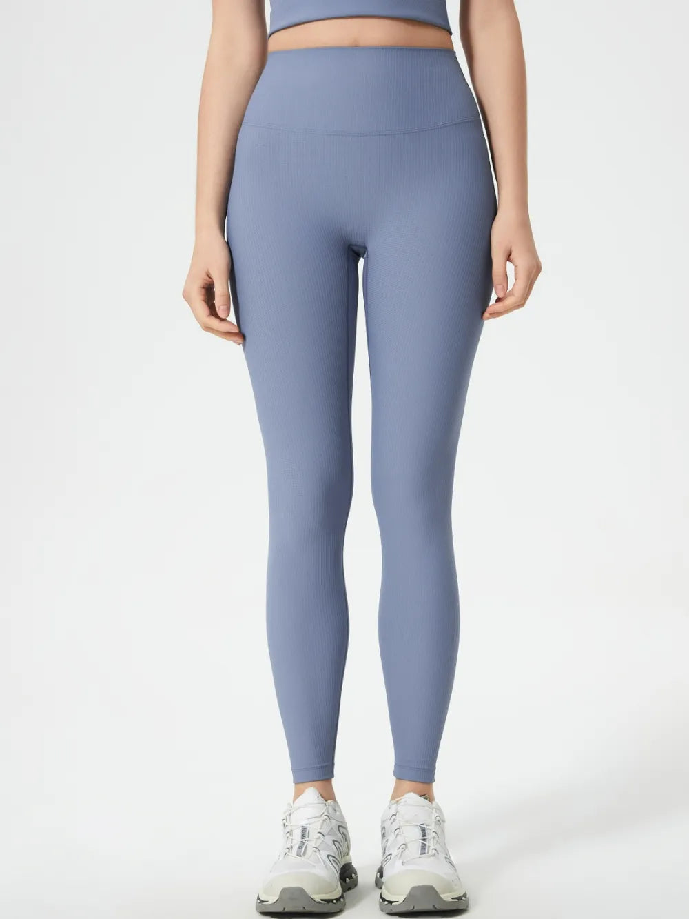 Person wearing light blue leggings on a white background