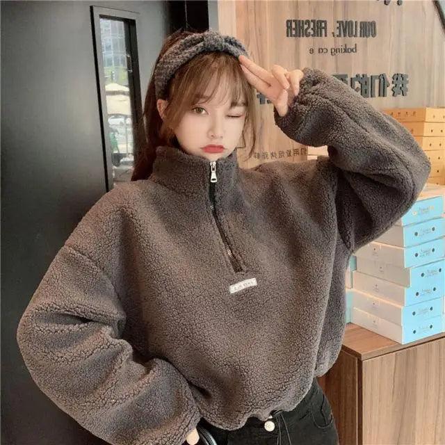 Person wearing a brown fleece pullover in an indoor setting