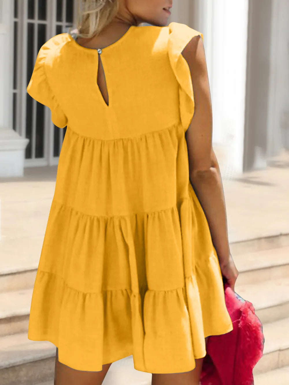 Woman wearing a yellow dress with a blurred background