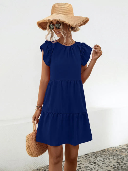 Woman wearing a blue dress and straw hat on a white background