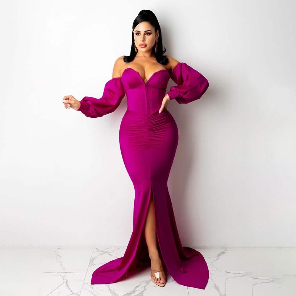 Woman wearing a vibrant pink evening gown with a high slit on a white background
Details