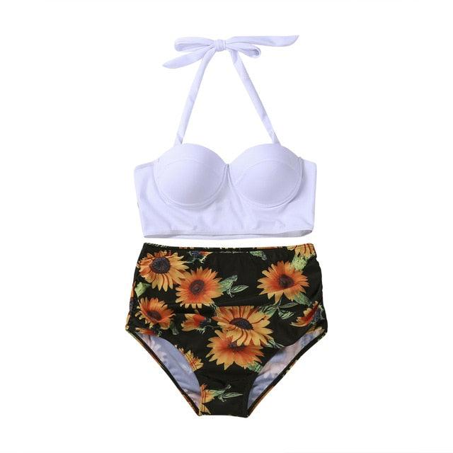 White bikini top and sunflower print bottom on a white background
