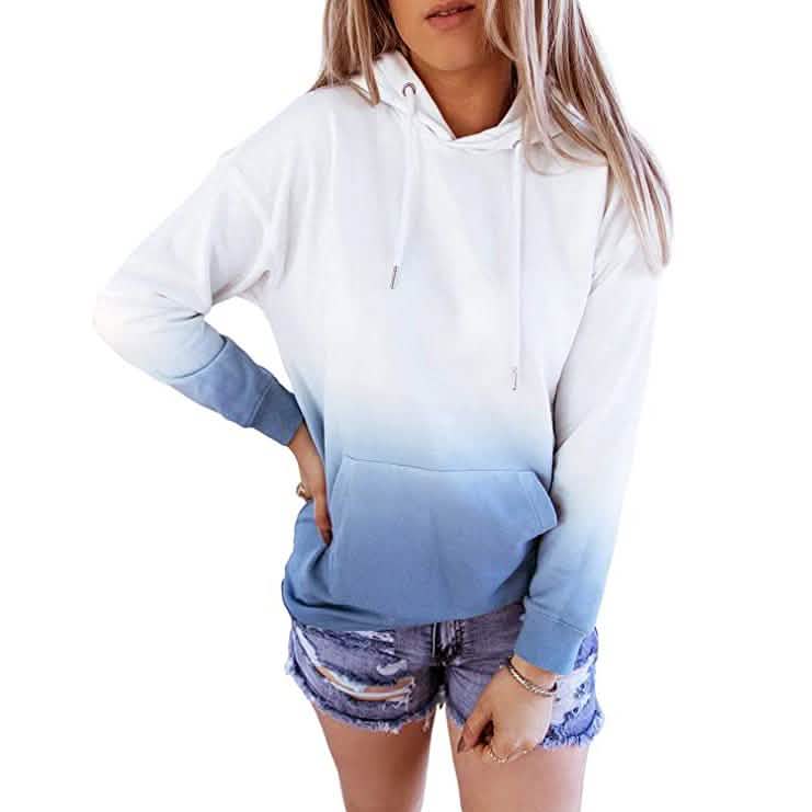 Woman wearing a gradient hoodie and patterned shorts on a white background